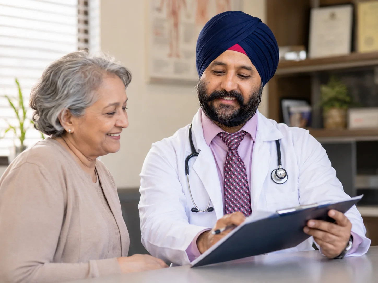 Doctor reviewing health plan with smiling senior patient
